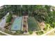 Aerial view of sports courts including a basketball court and a soccer field surrounded by lush trees at 5836 Sandy Springs Cir, Atlanta, GA 30328