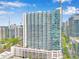 Modern high-rise building featuring a sleek glass facade and balconies with city skyline at 860 Peachtree Ne St # 1912, Atlanta, GA 30308