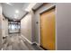 Well-lit hallway with patterned carpet, neutral walls, and unit entrance door at 860 Peachtree Ne St # 1912, Atlanta, GA 30308