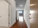 Hallway featuring hardwood floors leading to a living area with a city view through large windows at 860 Peachtree Ne St # 1912, Atlanta, GA 30308