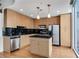Modern kitchen featuring stainless steel appliances, wooden cabinetry, and a view of the city at 860 Peachtree Ne St # 1912, Atlanta, GA 30308