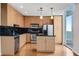 Modern kitchen featuring stainless steel appliances, wooden cabinetry, and a view of the city at 860 Peachtree Ne St # 1912, Atlanta, GA 30308
