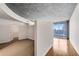 Open living area with hardwood floors, adjacent to bedroom, with large windows showing city skyline at 860 Peachtree Ne St # 1912, Atlanta, GA 30308