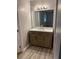 Bathroom vanity with wood cabinets, marble countertop, and large mirror with stylish lighting at 1150 Rankin Street # D1, Stone Mountain, GA 30083
