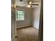 Bedroom showcasing window, carpet, ceiling fan, and neutral wall color at 1150 Rankin Street # D1, Stone Mountain, GA 30083