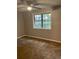 Bedroom featuring a ceiling fan, window with view, and carpeted flooring at 1150 Rankin Street # D1, Stone Mountain, GA 30083