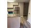 Bright kitchen featuring stainless steel appliances, granite counters, and wood-look flooring at 1150 Rankin Street # D1, Stone Mountain, GA 30083