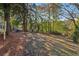 Spacious backyard with mature trees and lush greenery in a wooded setting at 2349 Springdale Rd, Atlanta, GA 30315