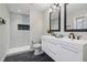 Modern bathroom featuring double sinks, sleek tile, and a glass shower at 2349 Springdale Rd, Atlanta, GA 30315