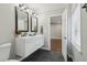 Bright bathroom with a double sink vanity, dark tile floor, and white cabinets at 2349 Springdale Rd, Atlanta, GA 30315