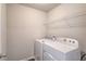 Efficient laundry room equipped with modern washer and dryer, plus practical shelving for storage solutions at 2378 Morgan Creek Rd, Buford, GA 30519