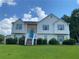 Charming two-story home with stone accents, blue door, and landscaped front yard at 3059 Brass Dr, Austell, GA 30106