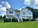 Charming two-story home with stone accents, blue door, and landscaped front yard at 3059 Brass Dr, Austell, GA 30106
