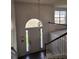 Bright foyer featuring arched window over the door and stairway to the second floor at 3059 Brass Dr, Austell, GA 30106
