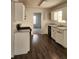 Kitchen with hardwood floors, white cabinetry, and marble countertops at 3059 Brass Dr, Austell, GA 30106