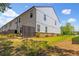 Rear view of the home's exterior showcasing the backyard, patio, and lawn at 4098 Haleston Rd, Duluth, GA 30097