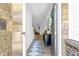 Welcoming entryway showcasing a stylish console table, rug, and a charming front door with brick accents at 4098 Haleston Rd, Duluth, GA 30097