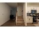 Inviting entryway featuring hardwood floors, staircase, and a modern kitchen with white cabinets at 4098 Haleston Rd, Duluth, GA 30097