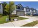 Row of well-manicured townhouses with attached garages and landscaped front yards at 4098 Haleston Rd, Duluth, GA 30097