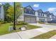Charming townhome exterior with a two-car garage and well-manicured lawn at 4098 Haleston Rd, Duluth, GA 30097