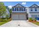 Charming townhome with stone accents, gray siding, a two-car garage and a well-manicured lawn at 4098 Haleston Rd, Duluth, GA 30097