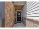 Inviting entryway featuring a decorative wreath on a black front door and a brick facade at 4098 Haleston Rd, Duluth, GA 30097