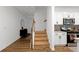 Hallway view featuring stairs, kitchen with island, and a decorative console table at 4098 Haleston Rd, Duluth, GA 30097