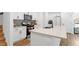 Stylish kitchen boasts a center island with a sink, white cabinetry, and modern appliances at 4098 Haleston Rd, Duluth, GA 30097