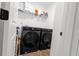 Laundry room features modern washer and dryer with shelving at 4098 Haleston Rd, Duluth, GA 30097