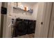 Convenient laundry room with modern washer and dryer units and storage shelves at 4098 Haleston Rd, Duluth, GA 30097
