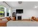 Cozy living room with fireplace, large windows, comfortable seating, and hardwood floors at 4098 Haleston Rd, Duluth, GA 30097
