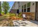 Back patio with a chair and small table in the fenced-in backyard at 4098 Haleston Rd, Duluth, GA 30097