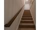 Carpeted staircase with wooden handrail providing access to the upper levels of the home at 4098 Haleston Rd, Duluth, GA 30097