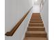Carpeted staircase with white trim and a wooden handrail at 4098 Haleston Rd, Duluth, GA 30097