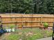 Fenced backyard featuring a garden area with planters and decorative garden art at 4172 Howell Park Road, Duluth, GA 30096