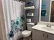 Bathroom featuring a white vanity, toilet, and shower with a decorative floral curtain at 4172 Howell Park Road, Duluth, GA 30096