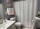 Bathroom with a shower-tub combo and soft decorative accents and white towels at 4172 Howell Park Road, Duluth, GA 30096