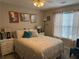 Cozy bedroom featuring a queen-sized bed with decorative pillows and framed art above the headboard at 4172 Howell Park Road, Duluth, GA 30096