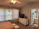 Cozy bedroom featuring bright windows, soft carpet, and access to an ensuite bathroom at 4172 Howell Park Road, Duluth, GA 30096