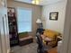 Bedroom featuring an accent chair, small sofa, and sports memorabilia at 4172 Howell Park Road, Duluth, GA 30096