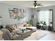 Comfortable living room featuring a sectional sofa, accent chairs, and large windows at 4172 Howell Park Road, Duluth, GA 30096