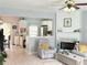 Cozy living room with fireplace, ceiling fan, and open view to the kitchen at 4172 Howell Park Road, Duluth, GA 30096