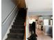 Carpeted stairway leading to upper level, with open view to kitchen and dining area at 4172 Howell Park Road, Duluth, GA 30096