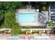 Aerial view of the community pool with ample seating and surrounding townhomes and landscaping at 6459 Chariot St # 35, Atlanta, GA 30328