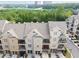 Aerial view of townhomes, each with garages and private balconies, surrounded by lush greenery at 6459 Chariot St # 35, Atlanta, GA 30328