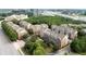 Aerial view of a community with multi-story townhomes and lush green spaces in a suburban setting at 6459 Chariot St # 35, Atlanta, GA 30328