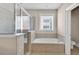 Bright bathroom featuring a soaking tub with tile surround and a glass enclosed shower at 6459 Chariot St # 35, Atlanta, GA 30328