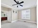 Bedroom with a ceiling fan, large window, and ensuite bathroom entrance at 6459 Chariot St # 35, Atlanta, GA 30328
