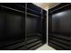 Walk-in closet with dark wood shelving and drawers for organized storage at 6459 Chariot St # 35, Atlanta, GA 30328