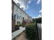 Charming townhome with brick accents, landscaped front, and inviting stairs to the front entrance at 6459 Chariot St # 35, Atlanta, GA 30328